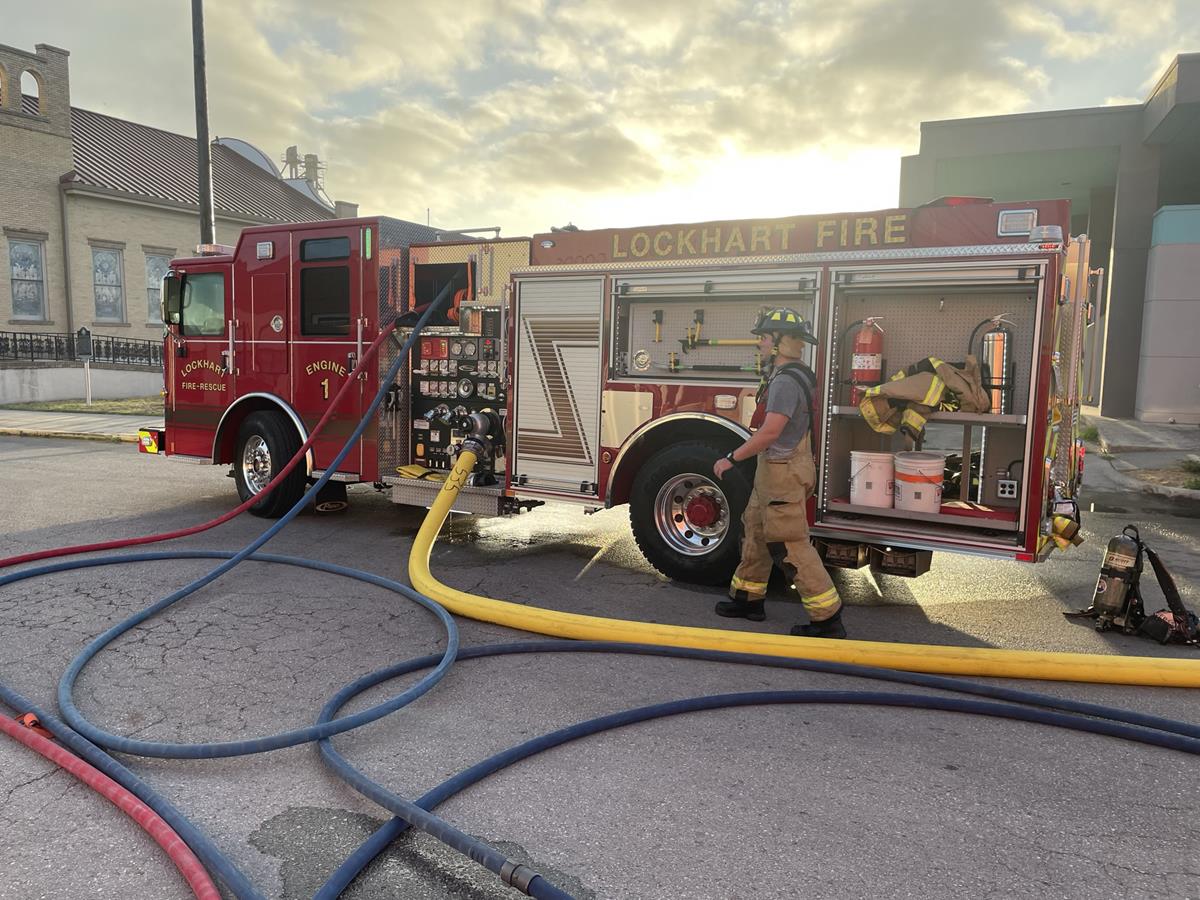 Firefighters spraying water hose